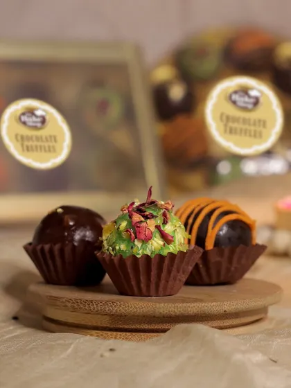 Showcasing our coconut rose truffle, this image captures the delicate texture and beautiful topping of rose petals. It's a unique flavor that combines floral notes with creamy chocolate.