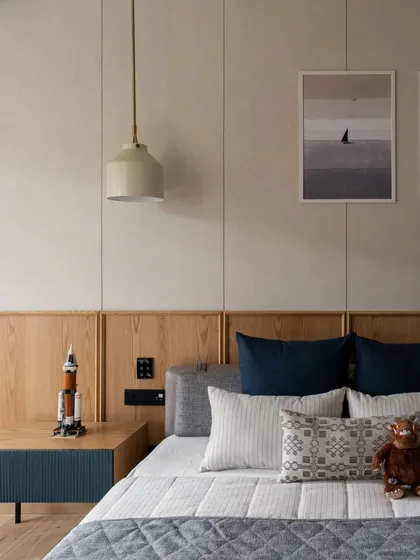 A close-up of the bed in the kids' room. The simple, clean lines of the furniture are complemented by playful bedding and art, creating a space that feels both modern and youthful.