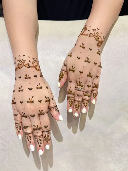 A very cute and modern design with bows and hearts, perfect for Teej or any fun celebration.