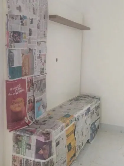Protecting your belongings is our priority. Here, we see a media unit fully masked, ready for the wall transformation to begin.