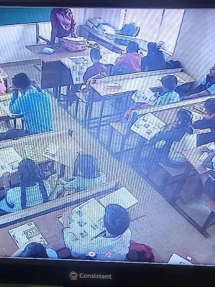 A view from the back of a classroom, showing all the students at their desks.