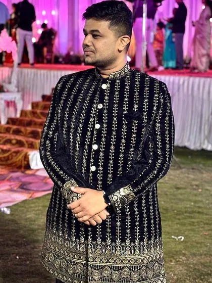 This is the look that turns heads at any wedding reception. A client looking sharp in our black velvet Jodhpuri suit with intricate silver embroidery. Renting this premium wedding outfit means you get the style without the hefty price tag.