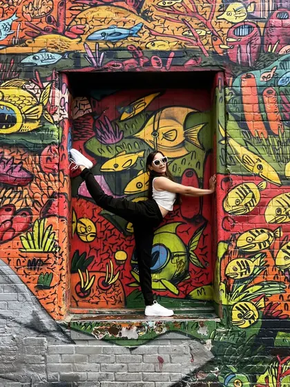 A fun throwback shot of me practicing a standing split variation against a vibrant graffiti wall in Toronto. Yoga can be practiced anywhere.