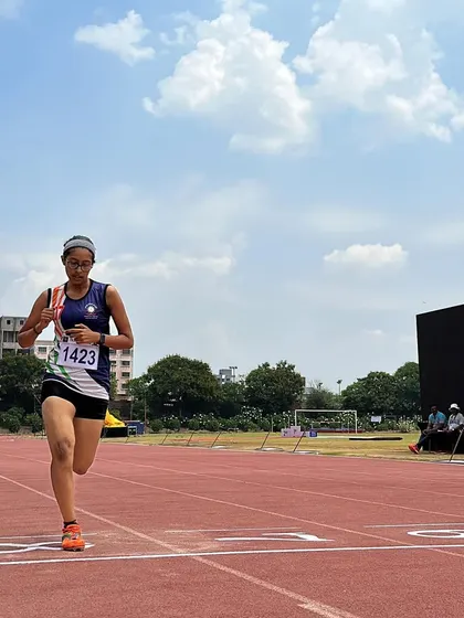 An athlete sprints towards the finish line at TrackNights Nashik, a picture of glory and determination.