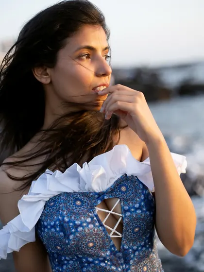 A close-up of the intricate corset top, highlighting the garment's design details and my expressive modeling.