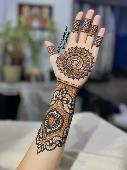 This design combines a central sun mandala with a bold, Arabic-style pattern on the wrist. You will learn how to blend different design elements to create a unique fusion look.
