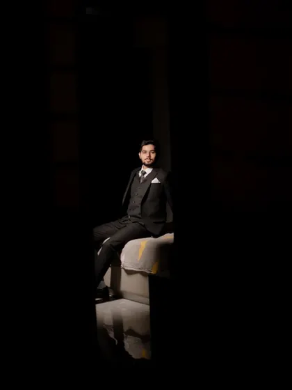 A creative and moody portrait of the groom-to-be, using shadows to create a dramatic and sophisticated look.