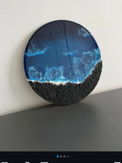 A dramatic dark resin art piece with a black sand effect and deep blue waves. This shows the versatility of resin art beyond the typical beach theme.