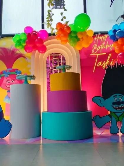 A close-up of the multi-colored tiered pedestals used as a cake stand for the Trolls party.