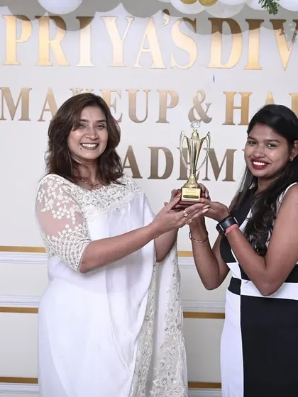 Awarding a trophy and certificate to a deserving student from Batch 13.