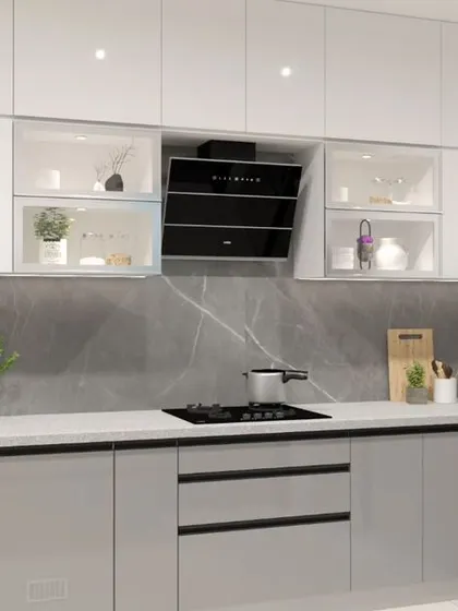 A minimalist all-white kitchen with a contrasting grey marble-patterned backsplash. The glass-fronted cabinets break the monotony and allow for displaying decorative crockery.