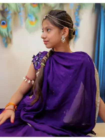 A lovely profile shot from a Radha-themed session, with soft lighting that enhances the traditional attire and accessories.