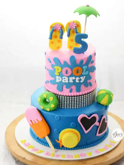 Time for a pool party. This fun, two-tier cake is decorated with everything you need for a summer celebration, including flip-flops, an ice cream pop, and a beach ball.