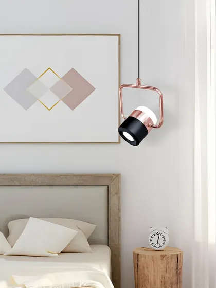 Another view of the adjustable spotlight pendant in a bedroom setting. Its modern design complements a variety of decor styles.
