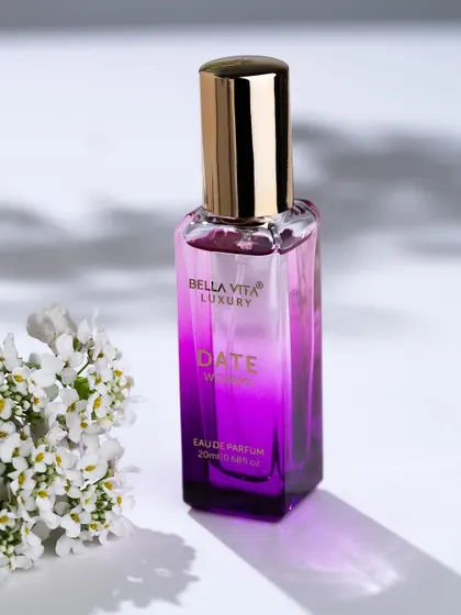This photo for Bella Vita Luxury perfume uses dappled light and delicate flowers to suggest the fragrance's scent profile. The lighting highlights the bottle's gradient color and elegant shape.