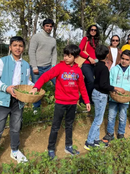 A family group posing in the vegetable patch, showcasing the multi-generational fun of our farm activities.