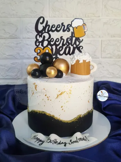 Cheers and Beers to 30 Years! A fun and stylish cake for a 30th birthday, featuring a "Cheers & Beers" topper and a mini fondant beer mug.