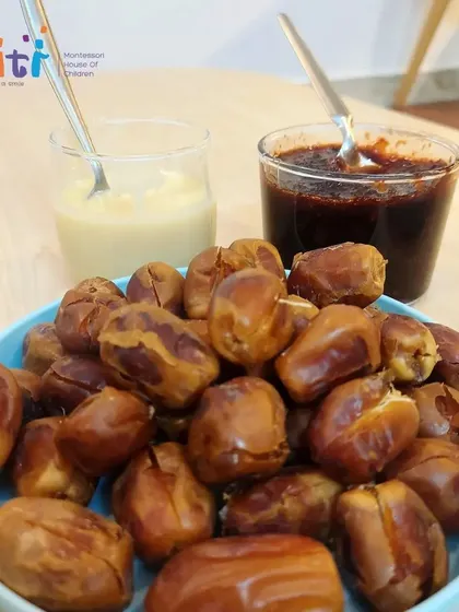 The simple, healthy ingredients for our Eid dessert: fresh dates, condensed milk, and date puree. We teach children about nutrition through hands-on cooking.