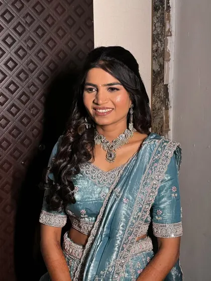 A happy portrait of the bride. Her open hairstyle with soft curls is modern, youthful, and perfect for the occasion.