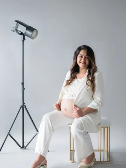 A behind-the-scenes glimpse of the studio setup for this modern maternity session. The simple background and professional lighting help create these clean, high-fashion inspired portraits.