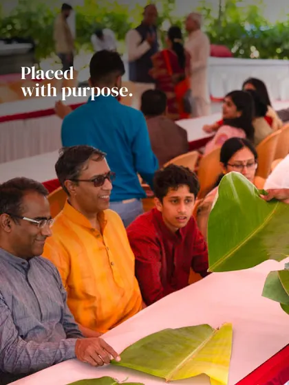 Placed with purpose. Guests at a traditional Yele Oota get ready to enjoy the feast, with banana leaves laid out in anticipation of the many dishes to come.