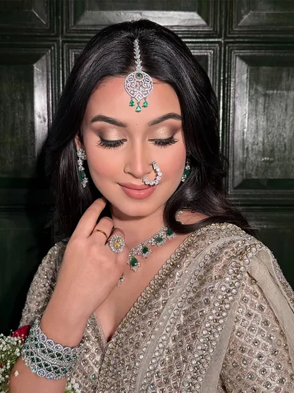 A beautiful soft glam look perfect for a wedding guest. The focus is on flawless skin and softly defined eyes, complemented by stunning emerald and diamond jewellery.