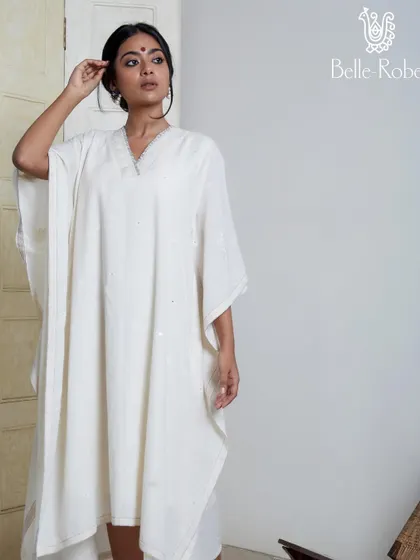 A minimalist and elegant makeup look for the brand Belle Robe. Featuring a simple bindi and natural-looking skin, this look is designed to complement the serene and classic aesthetic of the white kaftan.