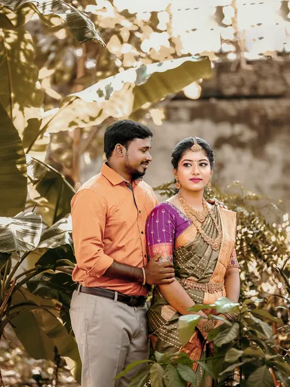 A lovely outdoor portrait that showcases the bride's elegant jewelry against her green and purple saree.