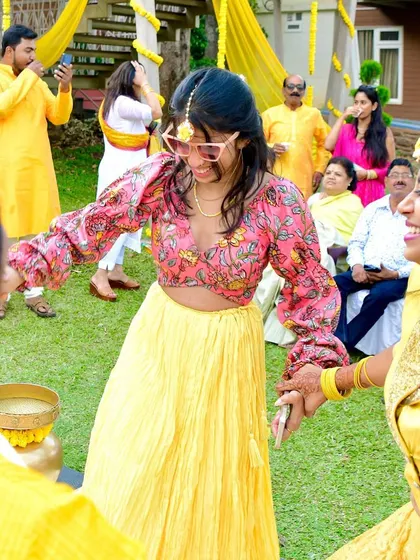 A vibrant Kalamkari blouse custom-made for Sanju. Paired with a simple yellow skirt, it creates a fun and festive look perfect for a Haldi ceremony.