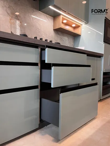 Smooth, handleless drawers with a soft-close mechanism. This close-up highlights the clean lines and precision of our cabinetry, where functionality is seamlessly integrated into a minimalist aesthetic.
