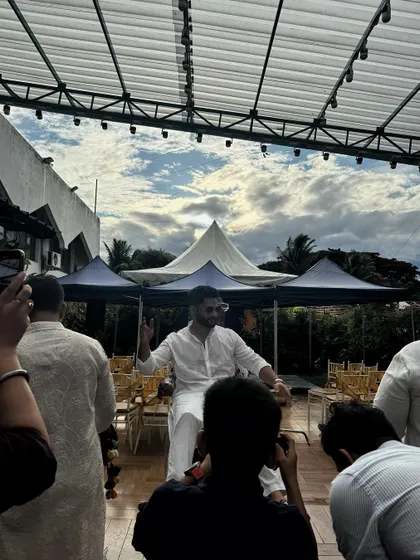 A guest enjoying the daytime festivities at our rooftop venue, with the open sky and canopies in the background.