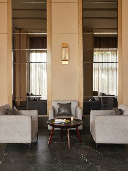 A seating area within the banquet hall, where mirrored wall panels and warm lighting create an intimate and elegant setting.
