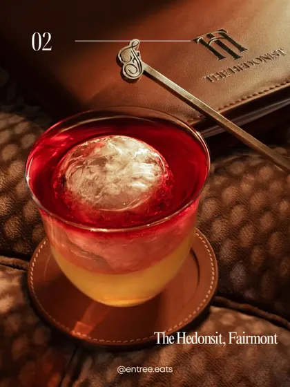 A vibrant, layered cocktail from The Hedonist, Fairmont. The lighting and composition in this shot emphasize the artistry of the drink, reinforcing the bar's place on my "best of" list.