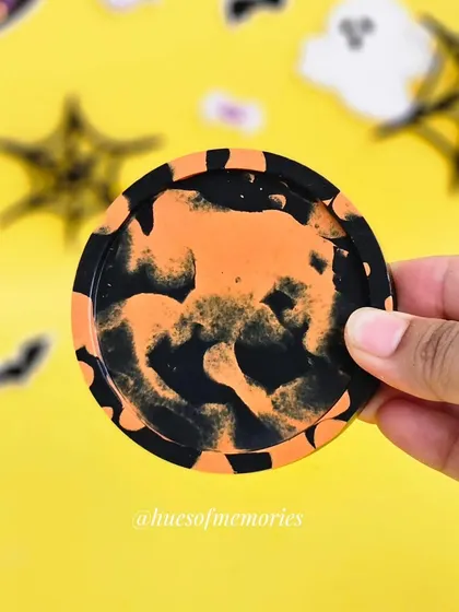 This mini coaster has a cool orange and black abstract pattern, like a spooky ink blot. Each one is handmade and completely unique.