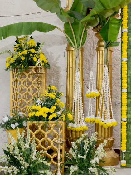 Traditional decor elements like banana pillars, jasmine strings, and golden accents create a sacred and beautiful corner for a wedding ceremony.