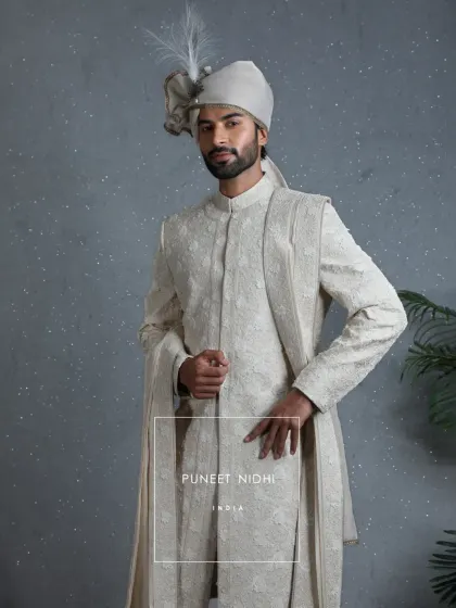 A closer look at the 3D floral embellished ivory sherwani with its matching stole. The design celebrates not just a ritual, but a journey of heritage and togetherness.