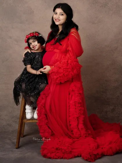 A sweet moment between mother and daughter. The big-sister-to-be is full of excitement for the new baby's arrival.