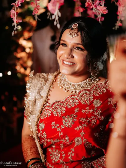 A happy, candid shot of the bride during her wedding celebrations.