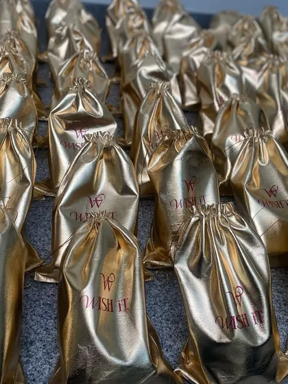 A frame full of gold. These custom Wishit potlis, shining and ready, were part of a large order heading to the US for a cultural celebration.