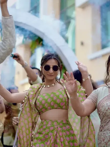 The bride makes a cool entrance with her parents, wearing sunglasses and dancing to the beat at her fun-filled Janya ceremony.