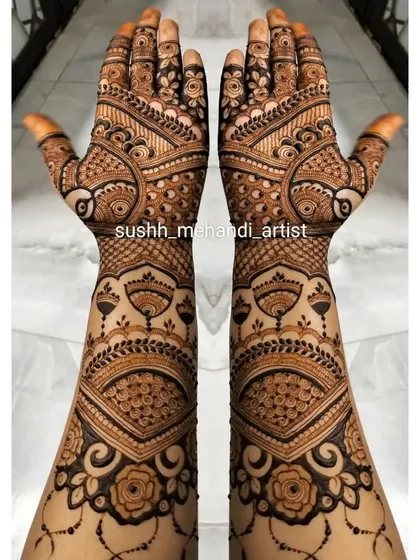 Full-arm bridal mehndi with a beautiful flow from the fingers to the elbow. The design is a mix of floral, paisley, and traditional motifs.