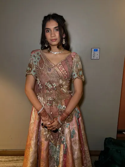 The full look for this wedding guest. She looks graceful and elegant in her pastel embroidered lehenga.