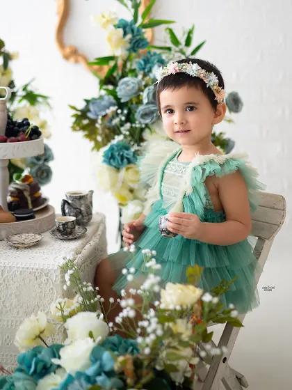 A close-up of the birthday girl enjoying her tea party.