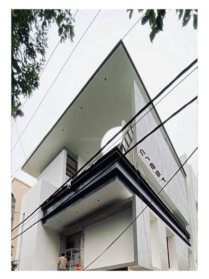 'Residence 96' nearing completion, with its final white plaster finish applied, highlighting its clean, angular lines.