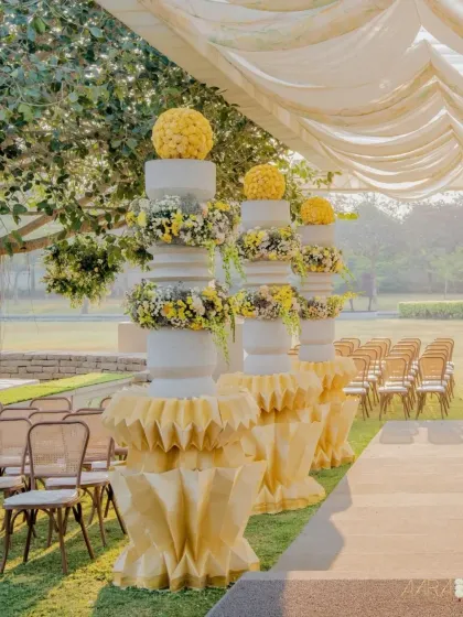 The aisle for our 'Golden Origami Garden' theme, lined with stunning paper origami pillars topped with marigold floral arrangements. The design evokes warmth, happiness, and sun-kissed elegance.
