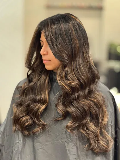 This hazelnut balayage is a beautiful mix of warm and cool brown tones, creating a unique and dimensional result.