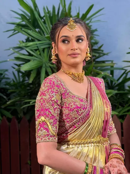 The complete engagement look. The modern hairstyle and soft makeup pair beautifully with her elegant saree.
