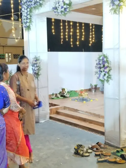 Here you can see guests enjoying the celebration under the decorated pandal. My goal is to create a comfortable and beautiful environment where you and your guests can relax and celebrate, while I take care of the setup.
