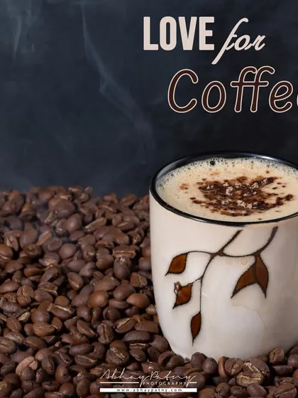 A creative concept shot for coffee. The steam and the bed of coffee beans create a powerful image that screams "freshly brewed" and "intense aroma."