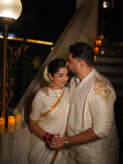 It was a joy to design this coordinated Deepavali outfit for the wonderful couple, Tharun and Sonal. For his off-white silk kurta, I added delicate, asymmetrical gold embroidery on the shoulder. This created a beautiful harmony with her matching saree, telling a cohesive story for their first festival together as a married couple.